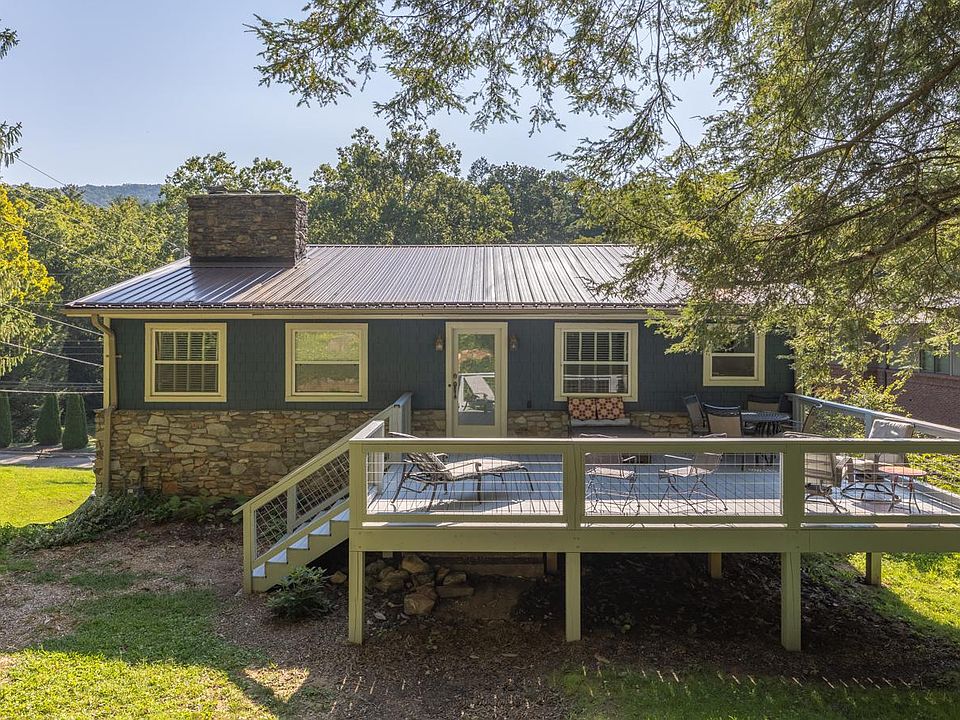 Large deck with ample seating under beautiful Hemlock trees