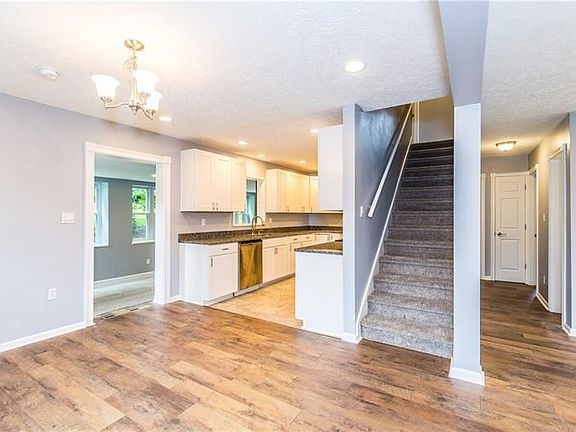 View of open floor plan from foyer showcasing brand new engineered hardwood flooring.
