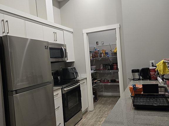 Kitchen, fully equipped with stainless steel appliances and pantry