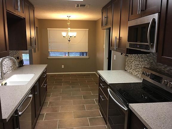 New electric stove and microwave. Attached breakfast area