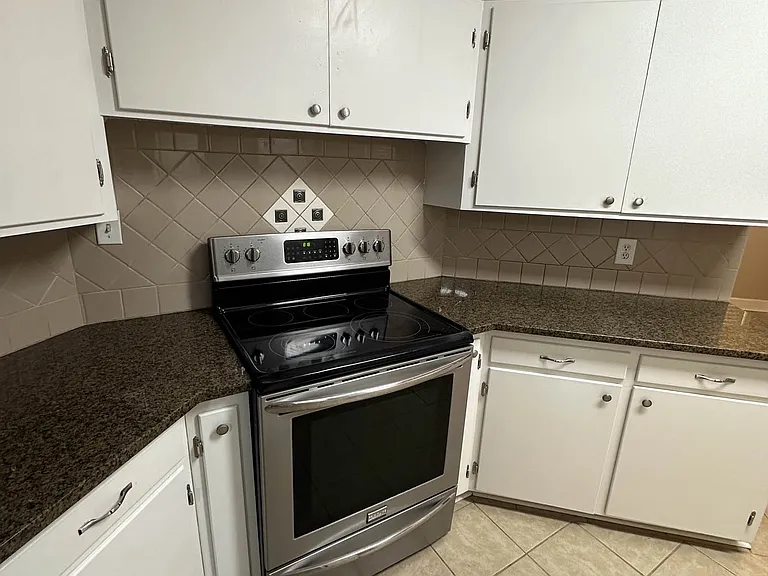Stove, counters, and cabinets