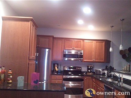 Kitchen with Cherry Cabinets, Granite Counter Tops & Tile Floor