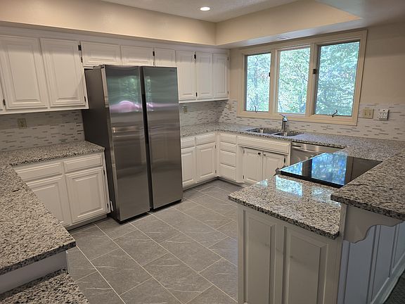Enjoy cooking and entertaining in this generously sized, recently updated, kitchen. Featuring modern updates, ample counter space and functional layout.