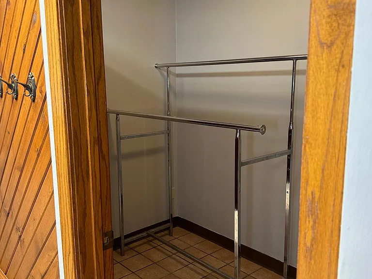 other closet in the entrance room with hooks on wall by door