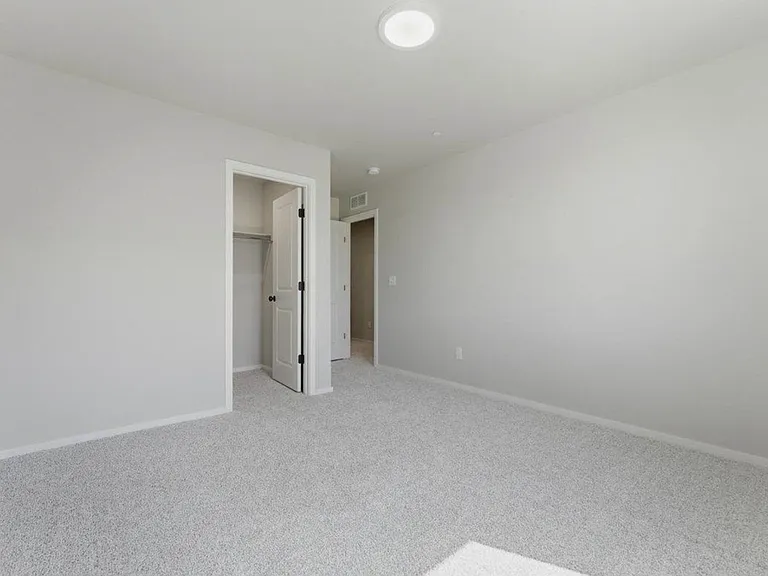 View of one of the guest bedrooms empty. East facing!