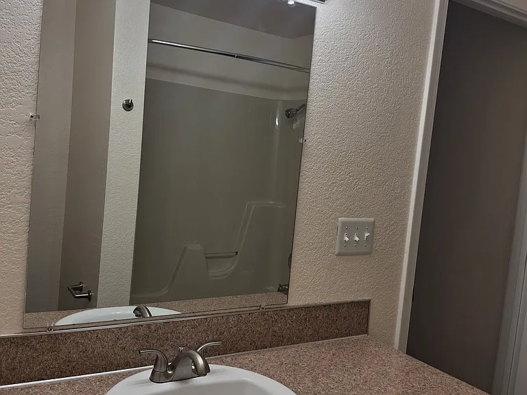 Bathroom cabinets and countertops vary in color and style