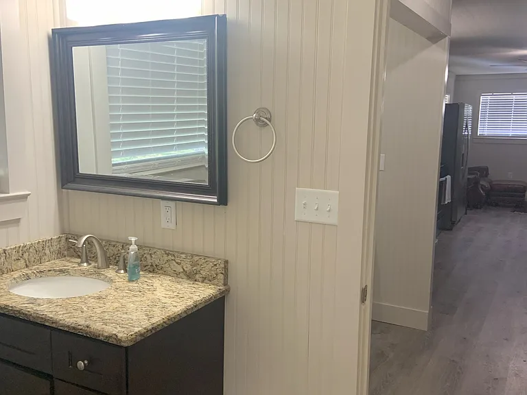 Granite top vanity in large bathroom