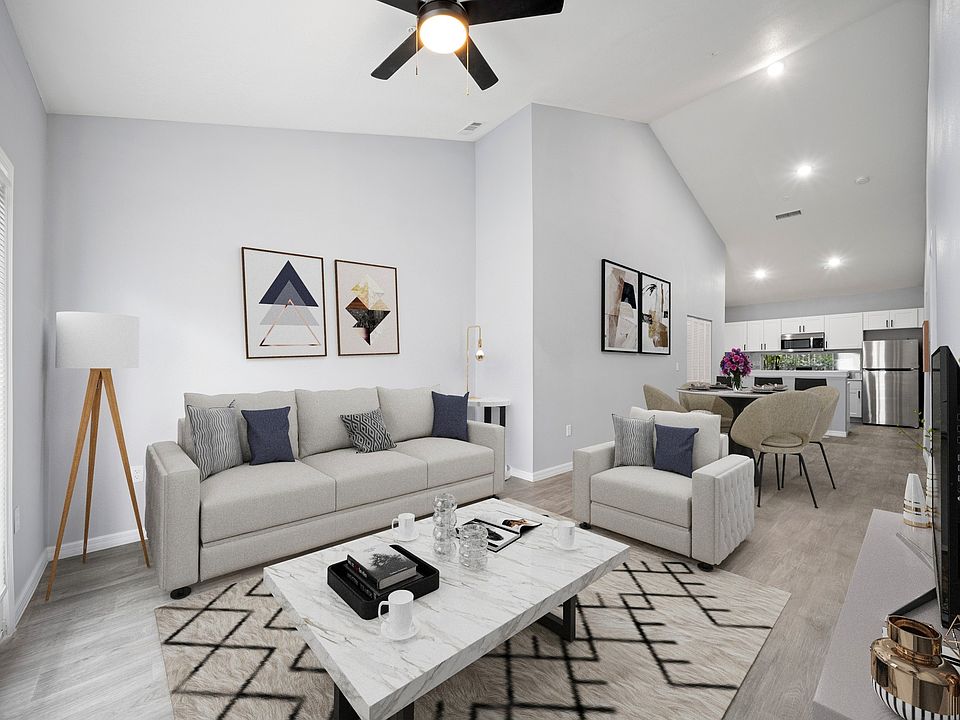 Model home fully furnished showing living, dining, and kitchen