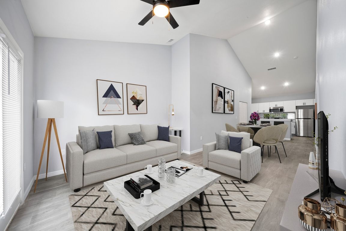 Model home fully furnished showing living, dining, and kitchen