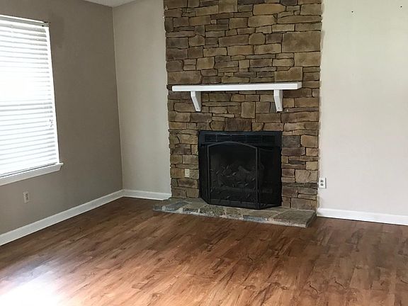 Gorgeous floors, white mantel sets this fireplace off with it's stone and the stone on the bottom is different so this is a one of a kind!