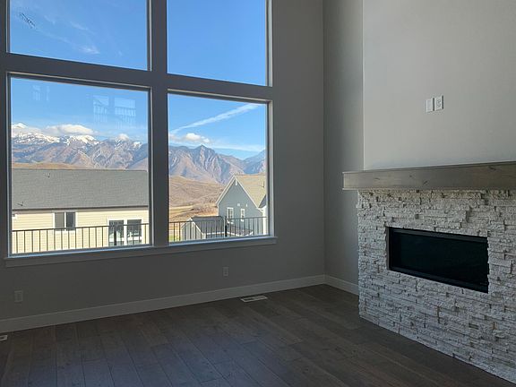 Great room has modern fireplace and mounted 60" TV (not shown)