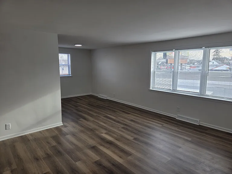 Just inside the front door looking towards dining room end of the living room. Kitchen is around corner to left.