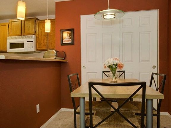 Dining area opens to living room. Great for entertaining. Designer colors & stylish light fixtures!