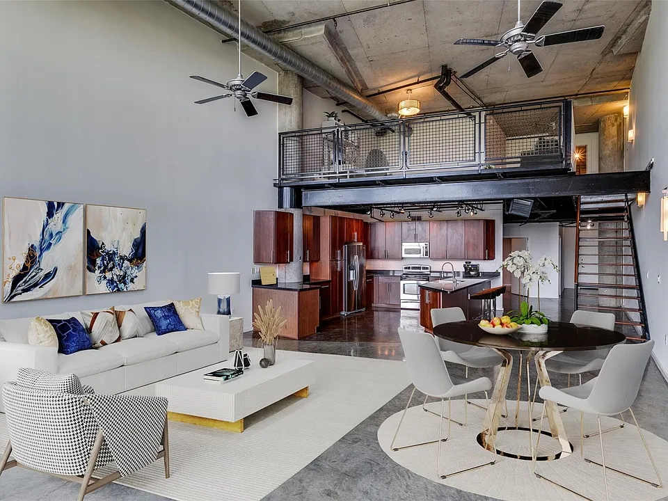 Industrial-style loft featuring high ceilings, exposed ductwork, and a concrete floor