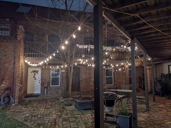 courtyard at night with fire pit, grill, and smoker