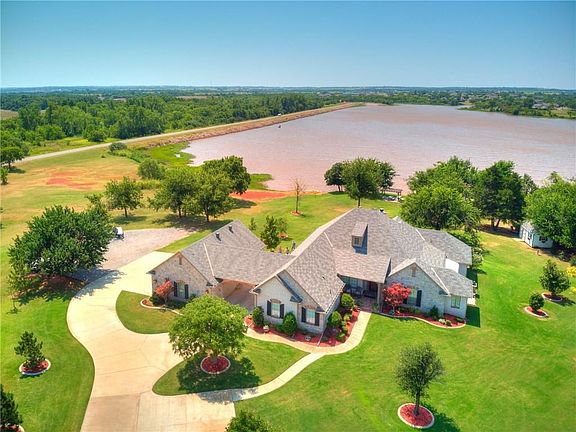Aerial view with driveways and lake view.