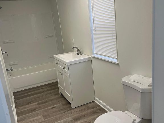 Large walk in bathroom with extra closet space for linens.