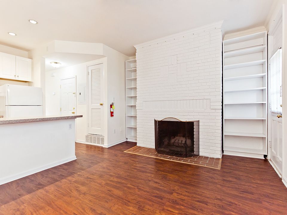 Living room with working fireplace and private rear exit door
