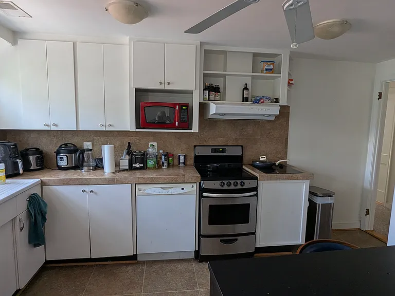 Kitchen showing cabinets, sink, dishwasher, microwave, stove, cooktop