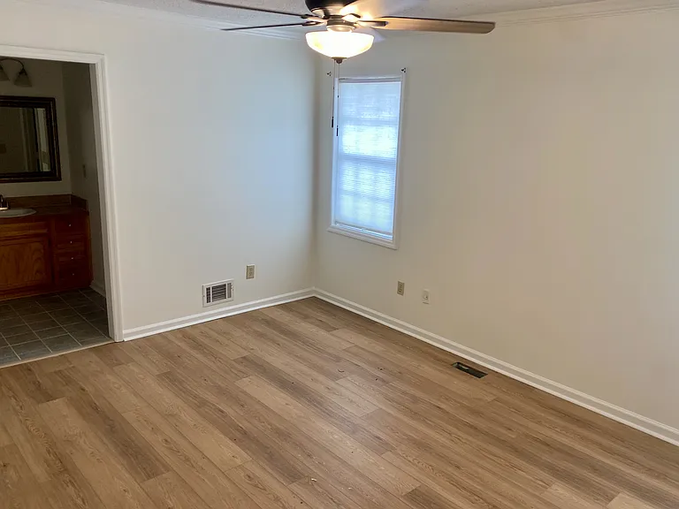 Easy living with wood floors and instant access to the bathroom vanity.