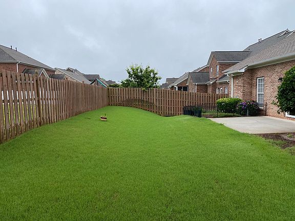 Backyard with patio and fenced in privacy fence.