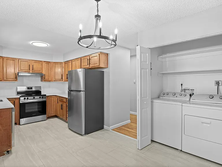 Explore this stylish kitchen and convenient laundry setup, perfect for modern living. Explore this stylish kitchen and convenient laundry setup, perfect for modern living.
