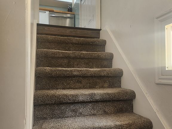 Stairs to basement off of kitchen and back door.
