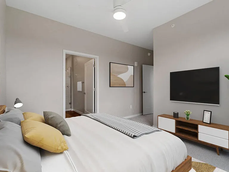 Bedroom with walk-in closet and en suite bathroom at The Hallon Luxury Apartments in Hopkins MN