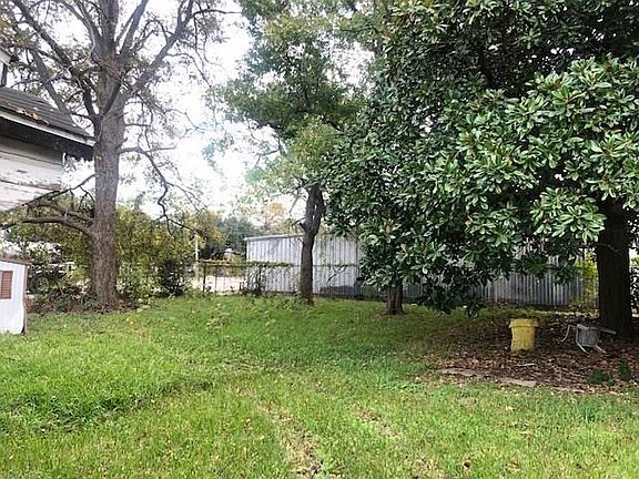 BACKYARD WITH LARGE TREES.