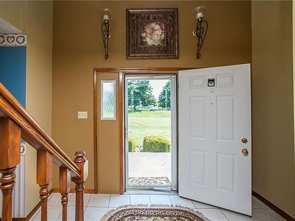 A tiled 2-story entry welcomes family and friends to your new home.  The opening on the left of the photo leads to the formal di
