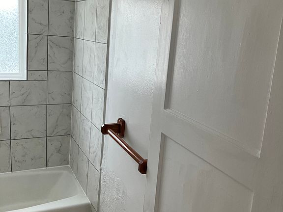 Bathroom Photo, newer paint, floor covering and shower tile. Also, water fixtures are newer.