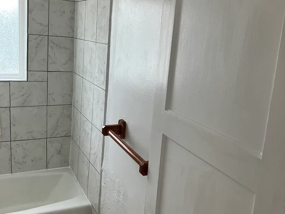 Bathroom Photo, newer paint, floor covering and shower tile. Also, water fixtures are newer.