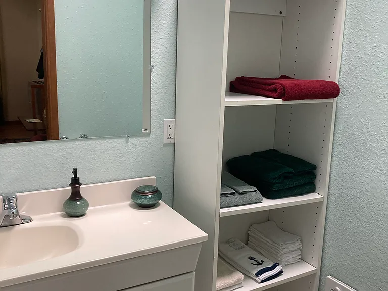 Enjoy the bright bathroom with skylight and plenty of room for your linens