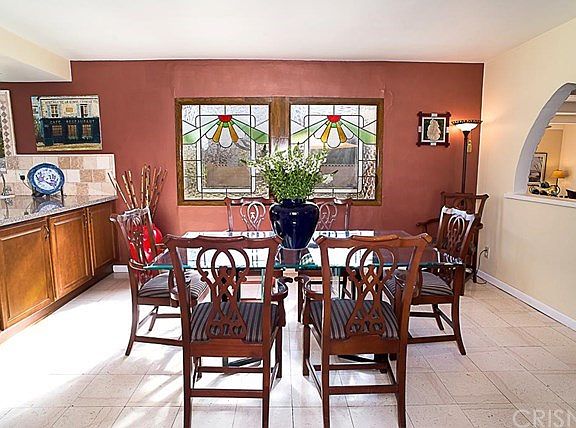 The kitchen dining area with stained glass windows over looking the backyard.