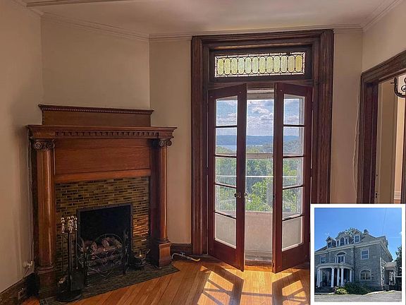 Period details in great room, entrance to large private patio with river views.