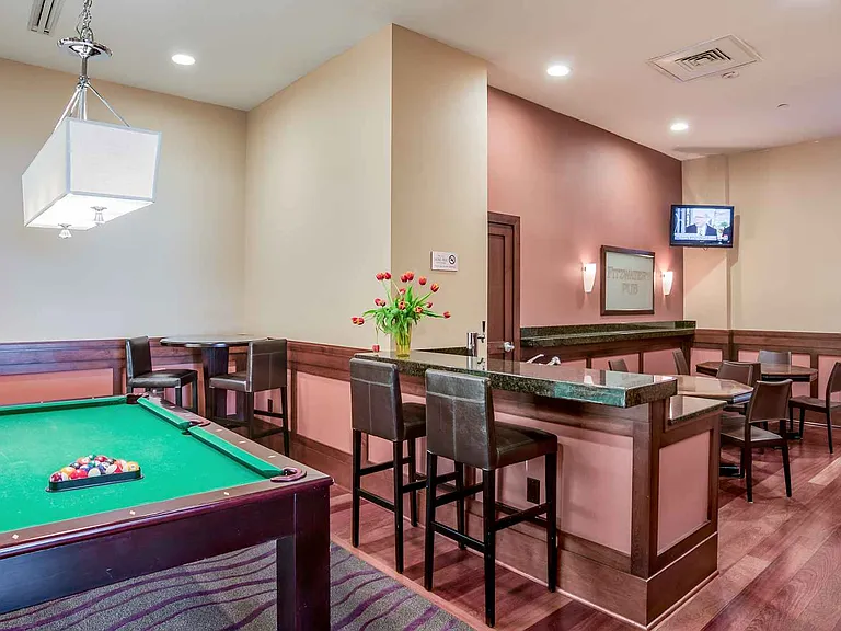 Clubroom with billiards and poker table