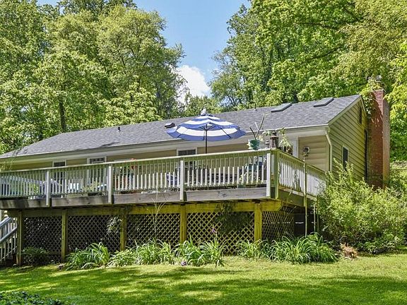 View of house and deck and yard from the back.