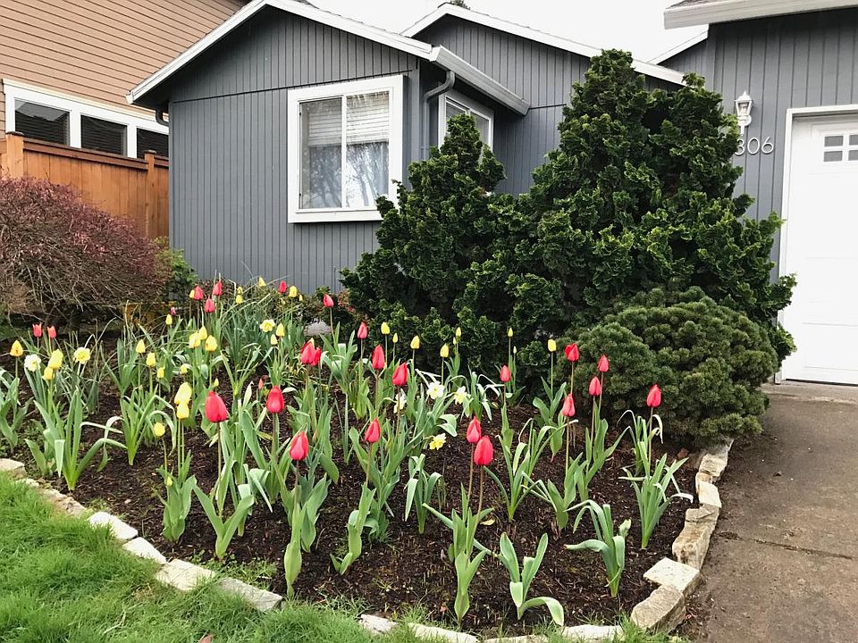 Enjoy the front bulb garden bed with blooms all spring and s