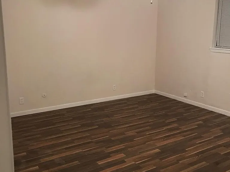 master bedroom with large walk in closet and flooring throug