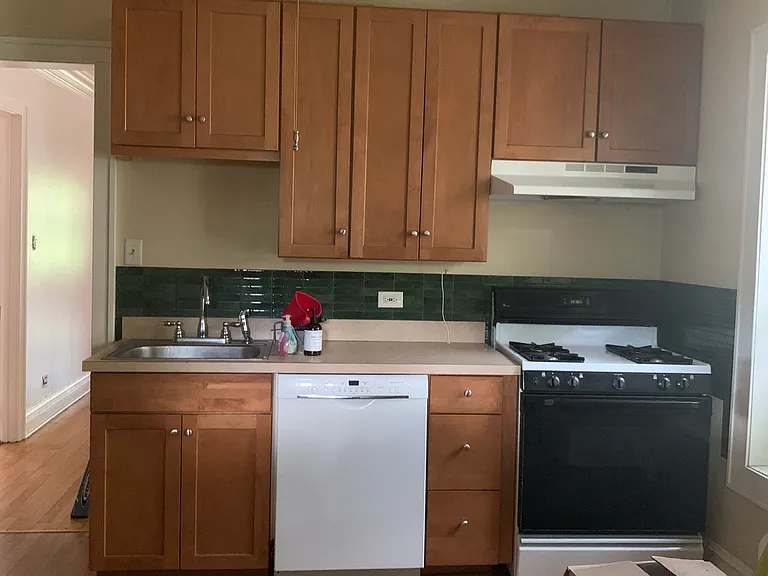kitchen with Bosch dishwasher. Large pantry cabinets and storage on each walls of the room