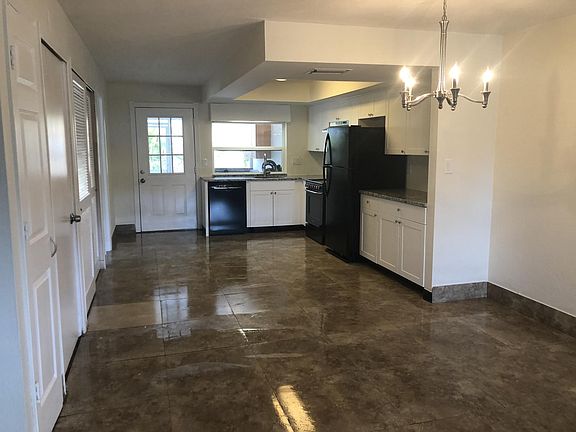 Brand new kitchen leading into large living room.