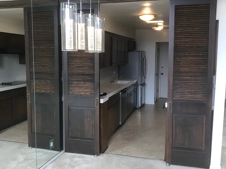 Dining Rm mirrored walls
to Kitchen. Sliding Panel Doors have been Removed to open up area.