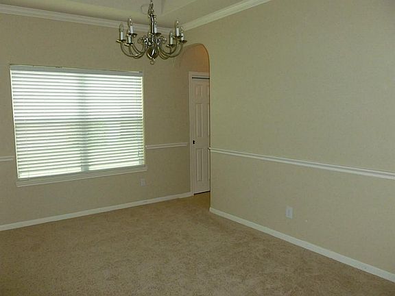 Formal dining room with access to kitchen.