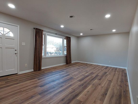 Large living room with lots of natural light and brand-new LVP flooring.