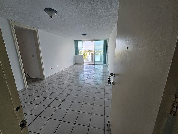 Foyer, dining area, living room, and balcony.