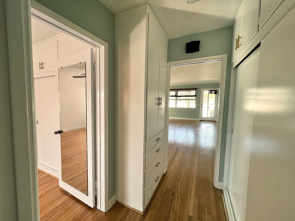 Hallway, leading into bedroom on the left, living room on the right.