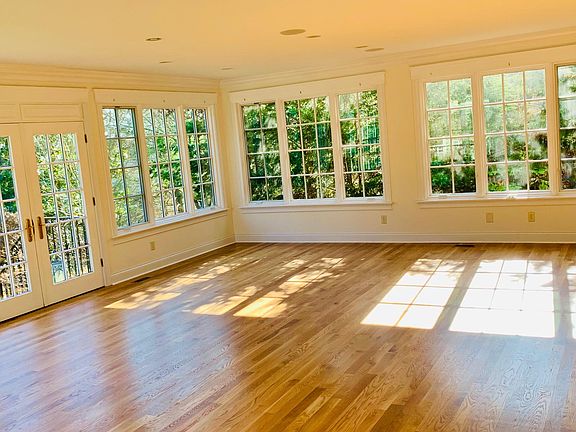 Sunroom surrounded by wooded lot