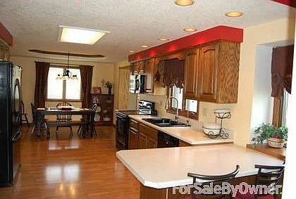 Kitchen : Oversized with plenty of storage and cabinets. Many updates. Laminate floor.