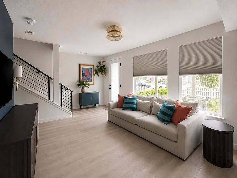 Living room featuring blackout blinds for privacy.
