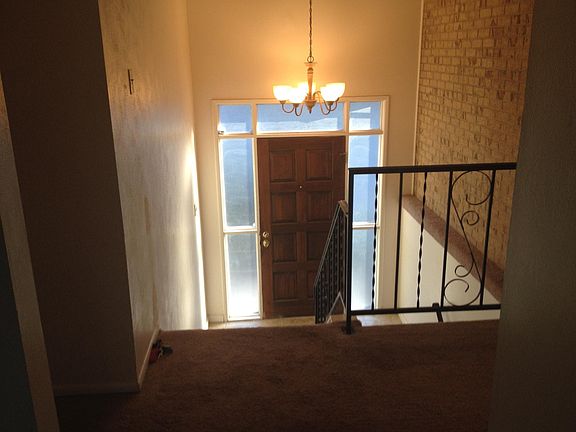 Entry Way. Upstairs to main living area and downstairs to garden level living room, bedroom, 3/4 bath, laundry area, and exit to oversized garage.
